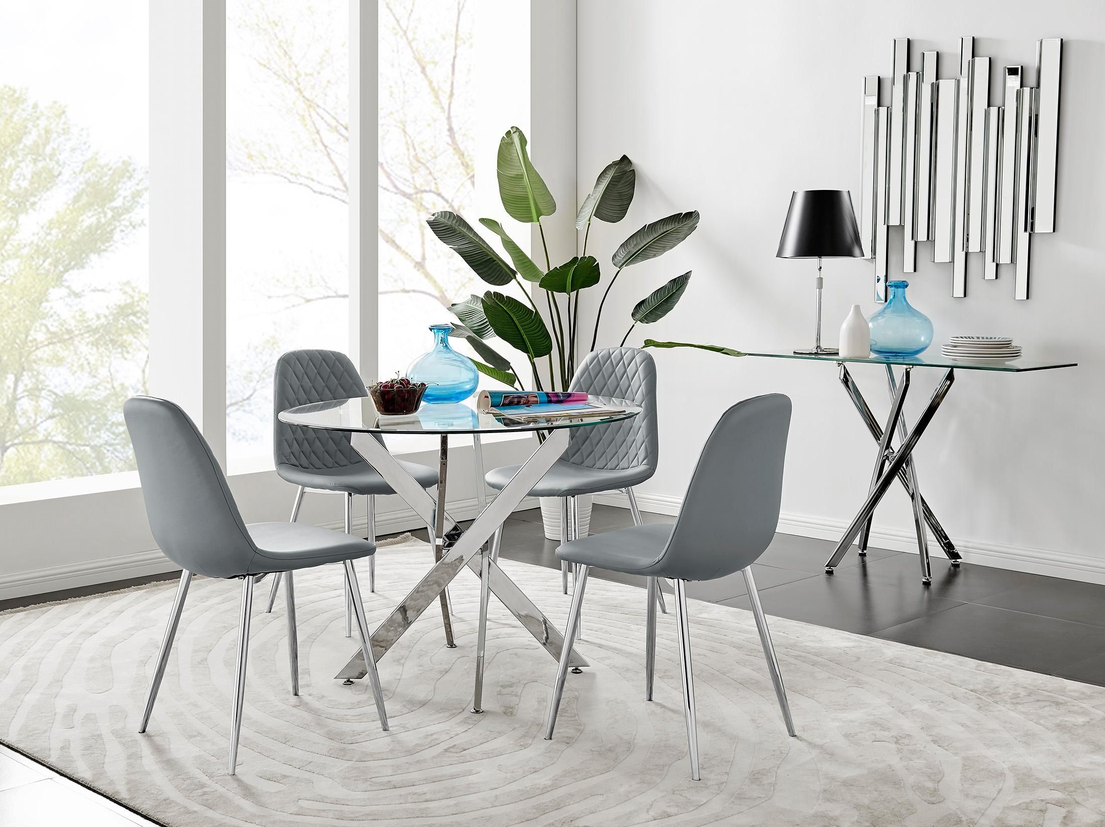 FurnitureboxUK Novara Clear Tempered Glass 100cm Round Dining Table with Chrome Starburst Legs & 4 Corona Faux Leather Silver Leg Chairs in Grey