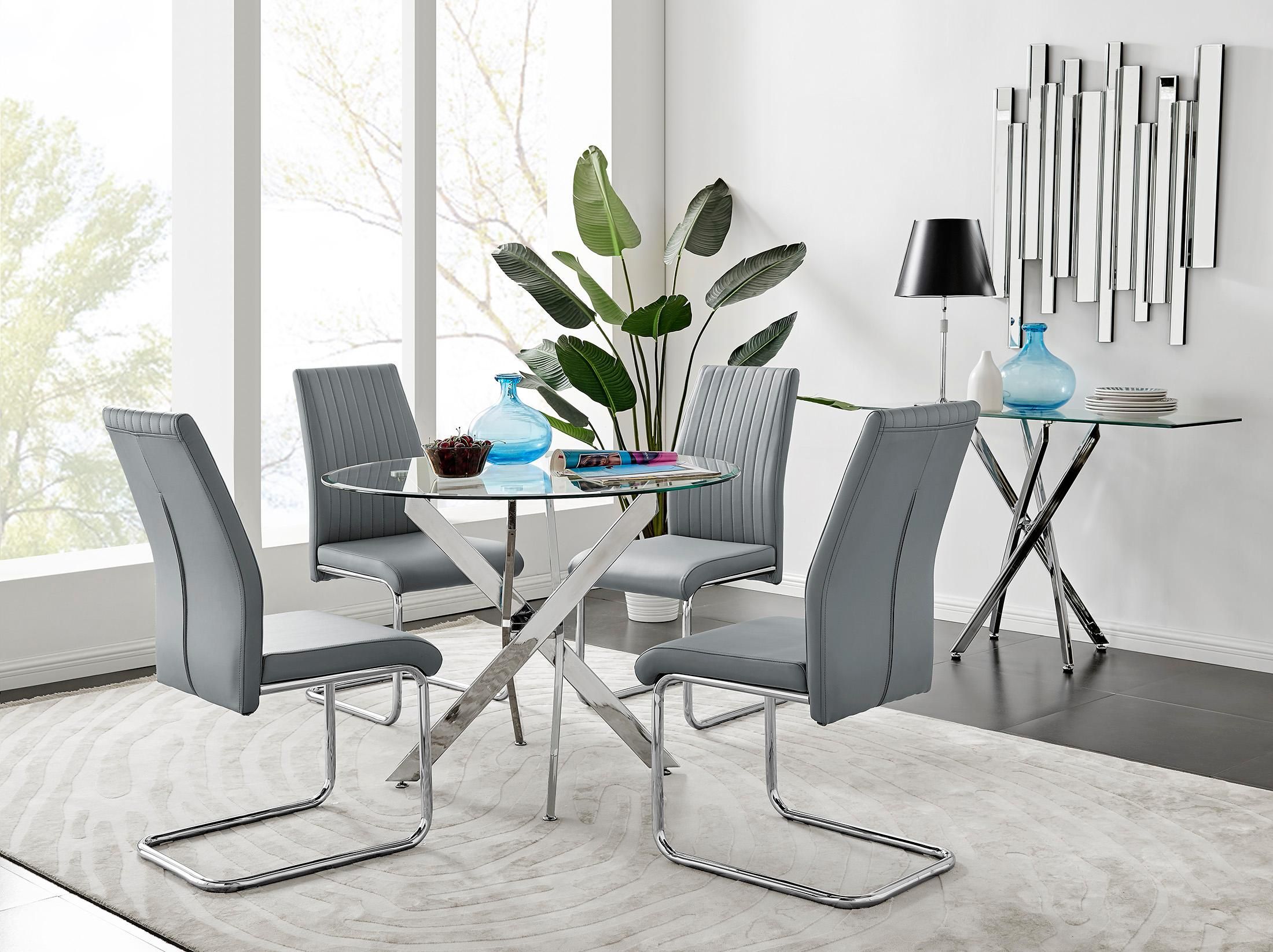 FurnitureboxUK Novara Clear Tempered Glass 100cm Round Dining Table with Chrome Starburst Legs & 4 Lorenzo Faux Leather Chairs in Grey