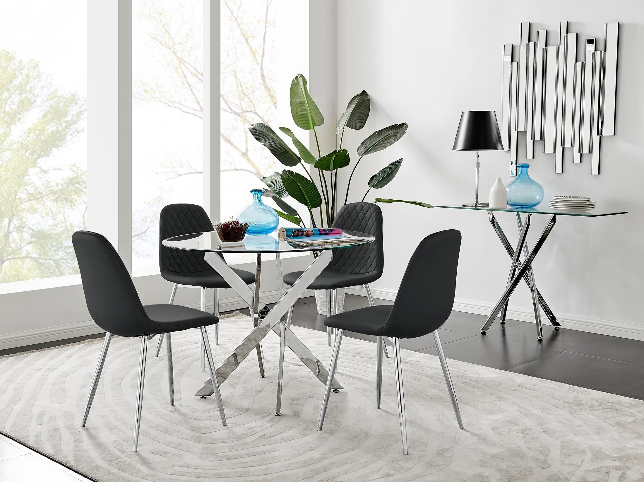 FurnitureboxUK Novara Clear Tempered Glass 100cm Round Dining Table with Chrome Starburst Legs & 4 Corona Faux Leather Silver Leg Chairs in Black