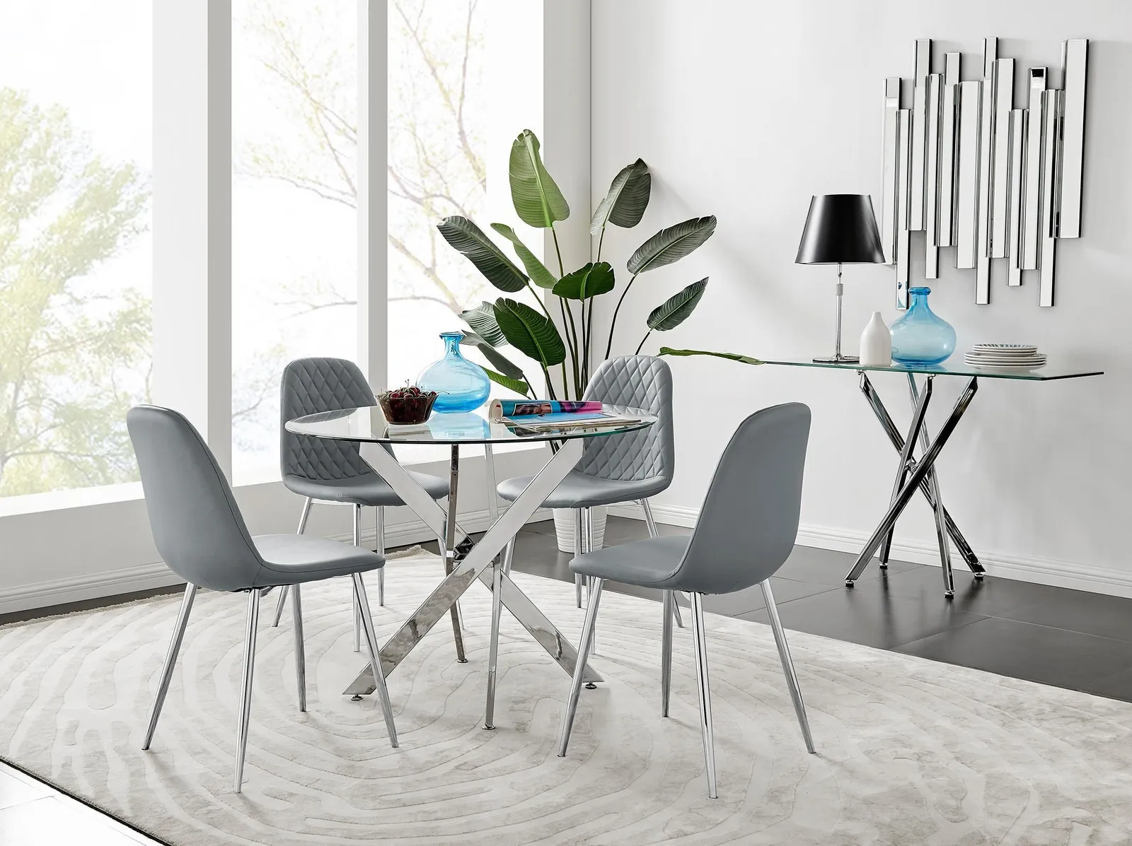 FurnitureboxUK Novara Clear Tempered Glass 100cm Round Dining Table with Chrome Starburst Legs & 4 Corona Faux Leather Silver Leg Chairs in Grey 1