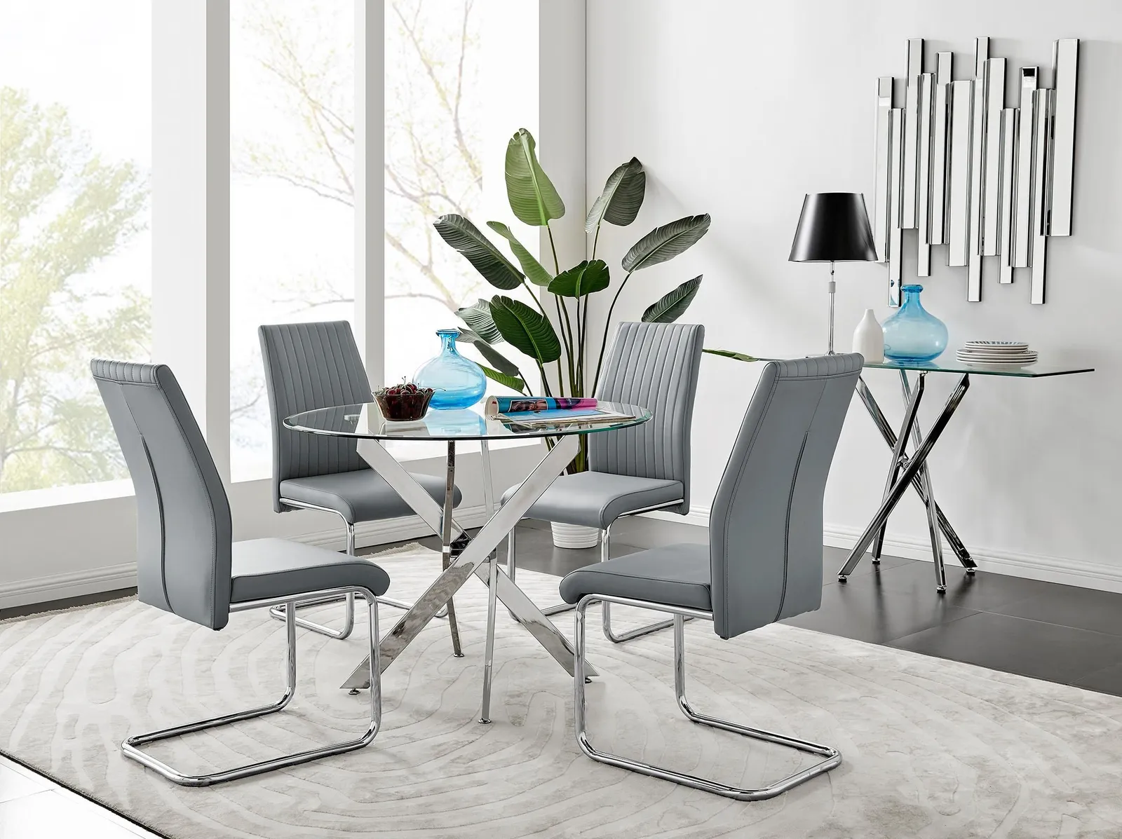 FurnitureboxUK Novara Clear Tempered Glass 100cm Round Dining Table with Chrome Starburst Legs & 4 Lorenzo Faux Leather Chairs in Grey 1
