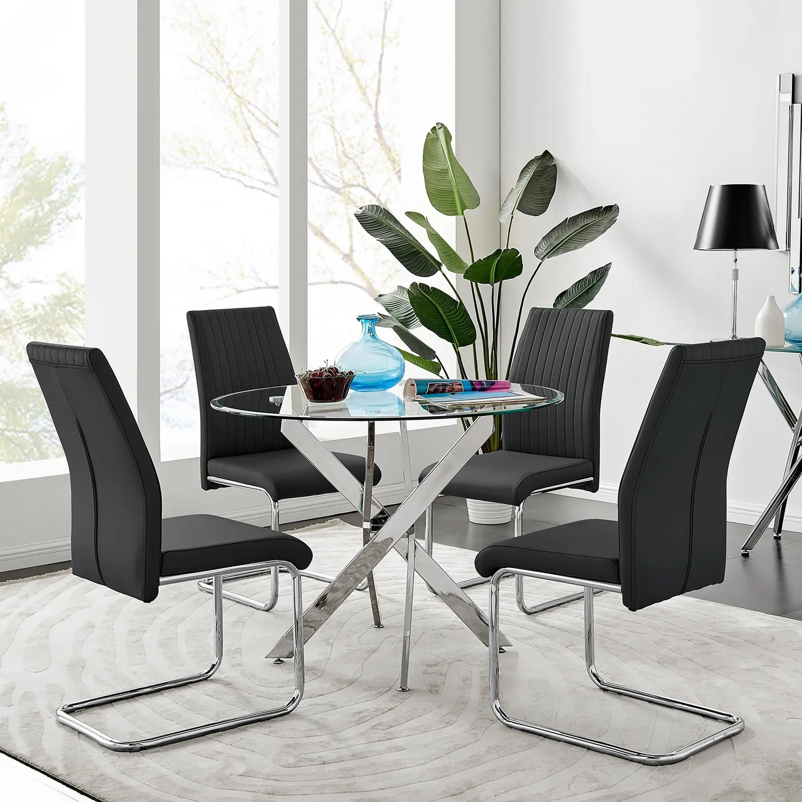 FurnitureboxUK Novara Clear Tempered Glass 100cm Round Dining Table with Chrome Starburst Legs & 4 Lorenzo Faux Leather Chairs in Black 1