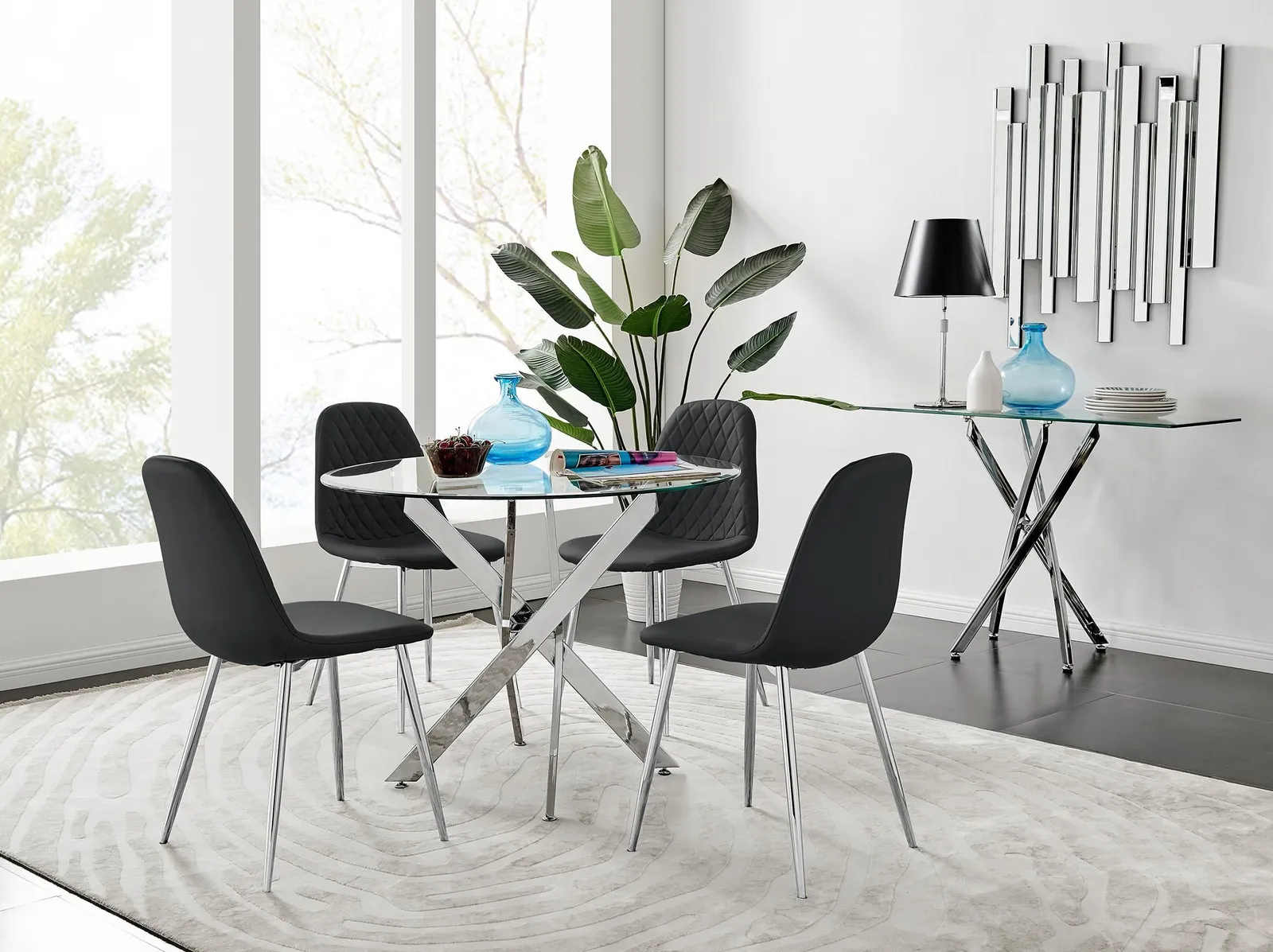 FurnitureboxUK Novara Clear Tempered Glass 100cm Round Dining Table with Chrome Starburst Legs & 4 Corona Faux Leather Silver Leg Chairs in Black